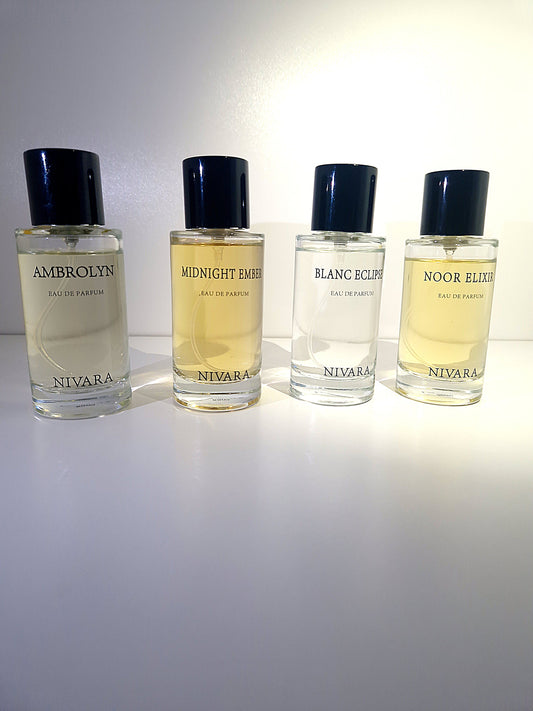 Four Nivara perfume bottles of different colours on a white background